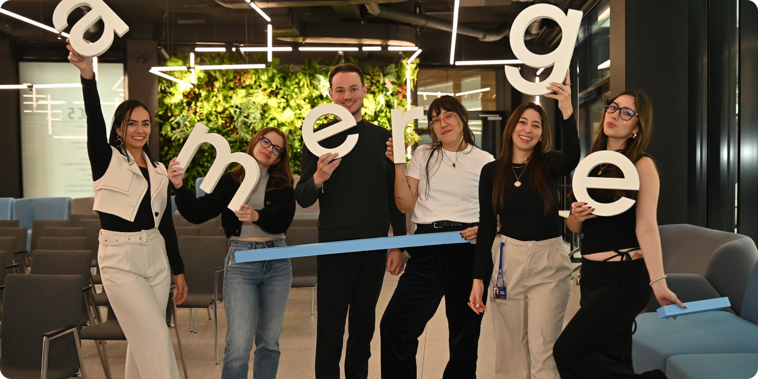 Amerge team members from different departments holding the company logo letters and celebrating a successful year, highlighting teamwork and company culture. Amerge team members from different departments holding the company logo letters and celebrating a successful year, highlighting teamwork and company culture.